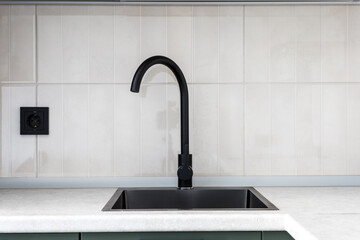 kitchen faucet on a stylish metal sink