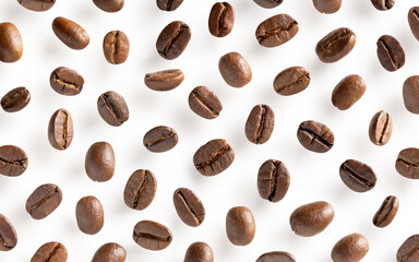 Roasted coffee beans. Scattered coffee beans on a white background with clipping paths. Close up.