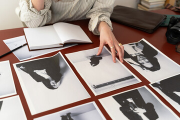Hands Reviewing Black-and-White Portraits
