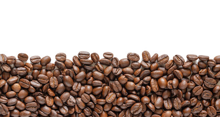 Many roasted coffee beans on white background. Coffee beans border with area for copy space. Close up images.