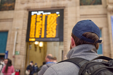 Man at a railway station checking schedule