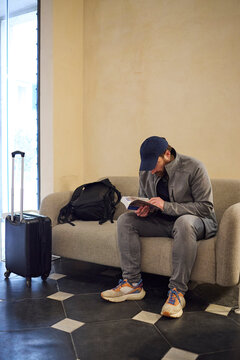 Young man spending time in a hotel lobby