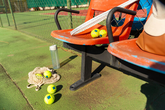 Tennis Equipment on Orange Stadium Seats

