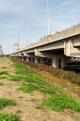 Concrete structure and asphalt road space under the overpass in the city