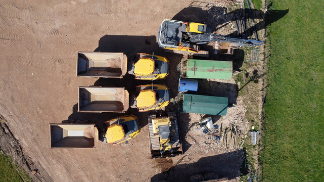  Aerial view of quarrying vehicles parked by a field