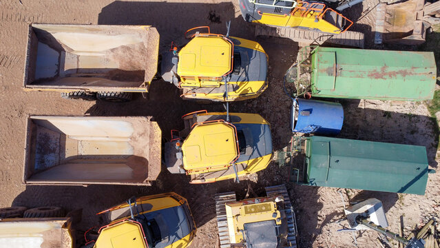  Aerial top down view of dumper truck  vehicles parked by a field