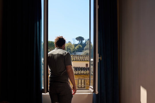 A young man in a hotel room 