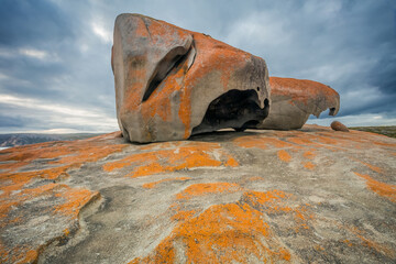Lichen covered rock formations in front of a dark sky
