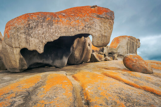 Lichen covered rock formations in front of a dark sky