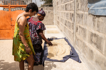 Women drying fonio in Senegal, Africa