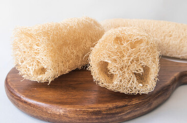 Loofah bath scrub sponge on wooden background