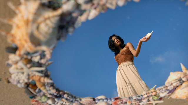 Asian woman with a  mirror made of shells