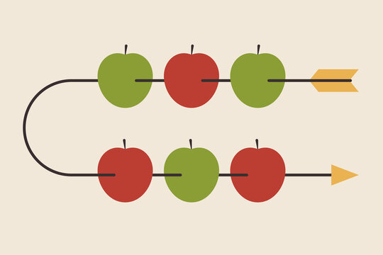 Red and green apples pierced by arrow