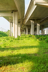 Obraz premium Concrete structure and asphalt road space under the overpass in the city