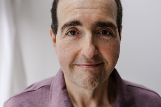 Portrait of a Smiling Middle-Aged Man in Casual Attire Indoors
