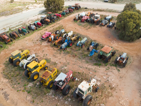 Colorful old tractors parked in rows