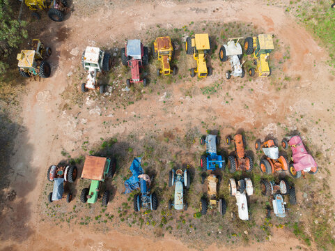Colorful old tractors parked in rows