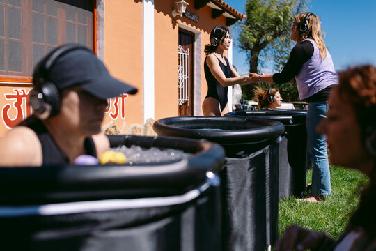 Women participating in a guided meditation session in the open air