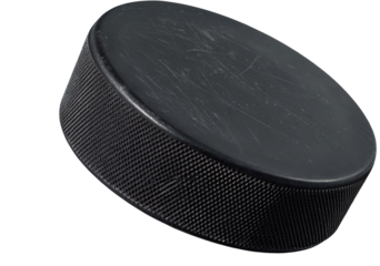 A close up studio shot of a black hockey puck on a black background with a slight angle and texture