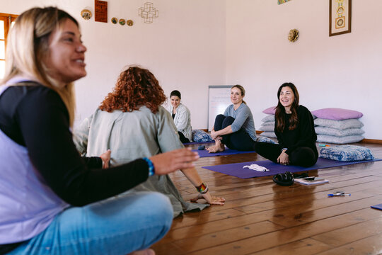 Women practicing breathing exercises during meditation session