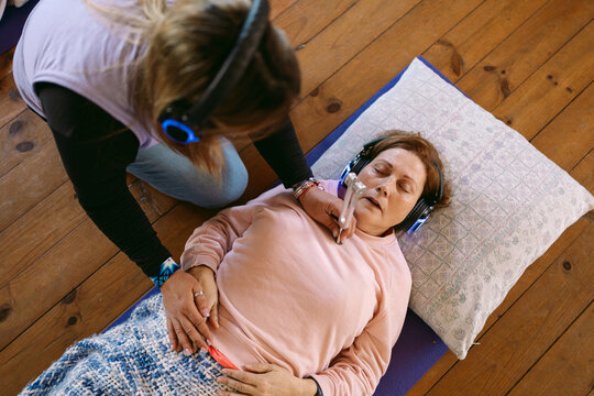 Therapist using tuning fork during sound healing therapy session