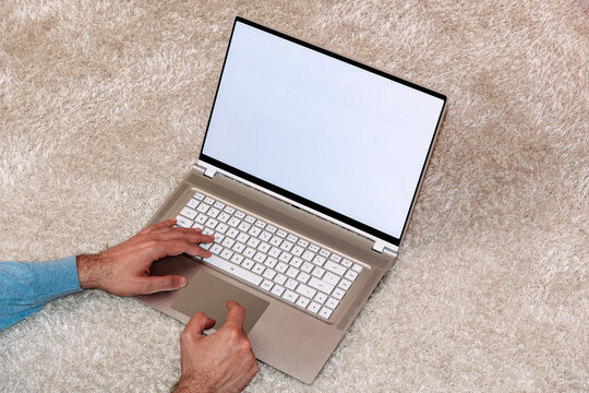 Person holding modern laptop with blank screen. Mock-up. 