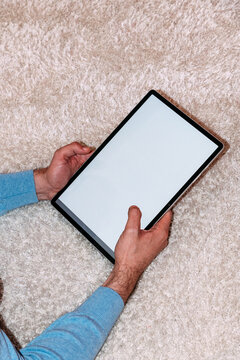 Person holding modern tablet with blank screen. Mock-up. 