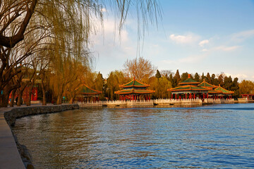 Beijing Beihai Park lakeside Five-Dragon Pavilion and weeping willow scenery.