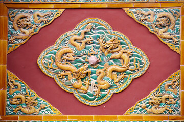 Traditional Chinese glazed two dragons playing with a pearl relief.