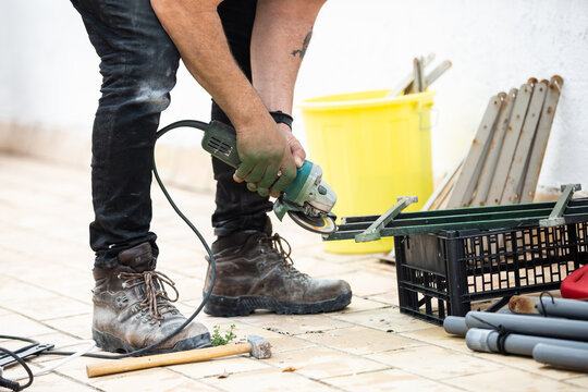 mans hands using power tool