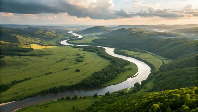 Aerial view of winding river through green hills and cloudy sky - Powered by Adobe