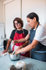 Two women soaking wool in their workshop