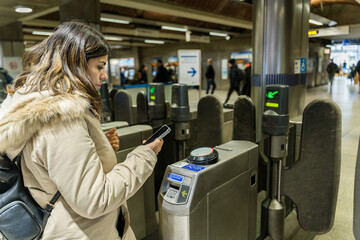 woman using smartphone to access public transport in London