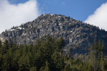 Rocky mountain peak against blue sky.