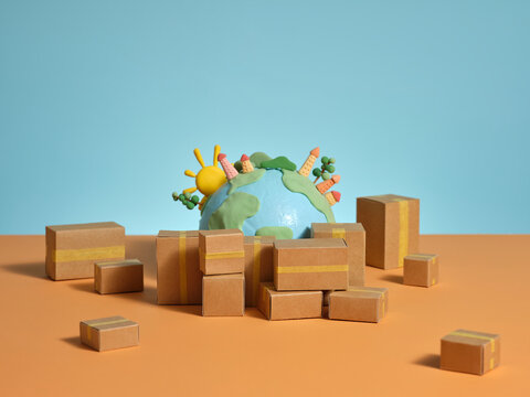 Cardboard boxes surround a handmade globe with a sun