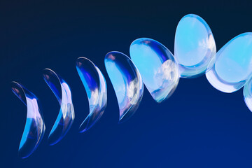  Minimalist abstract glass forms arranged in blue fluid spiral