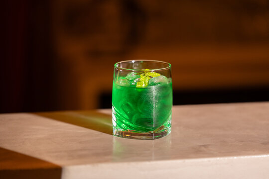 Green mint liqueur cocktail on bar counter