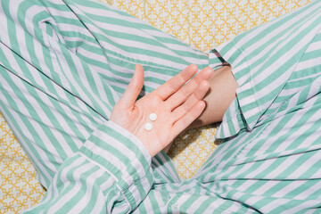 Hand Holding Melatonin Sleep Aid Pills