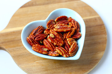 Delicious salted pecan nuts scattered.