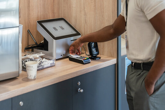 Person using payment terminal at service counter