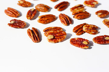 Delicious salted pecan nuts scattered.