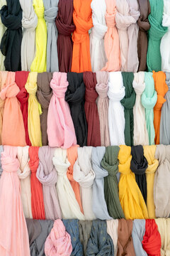 Fototapeta Background of multicoloured scarves tied on a sales stand