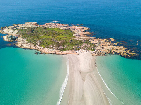 Narrow sand bar leading to a rocky island