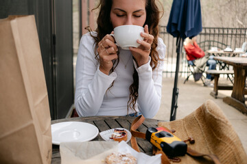 young woman enjoying a drink  in a  café 