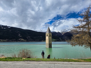 Experience the stunning and breathtaking view of a submerged tower in an enchanting alpine lake...