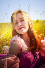 Young woman enjoying a sunny day in a vibrant flower field with a joyful expression caught on camera