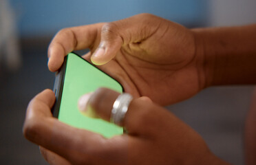 Person using smartphone with green screen for copy space