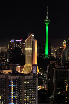 KL Tower and golden skyscraper at night