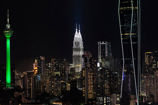 Petronas Towers and Merdeka 118 at night in city