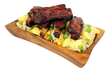 Mini Chinese barbecue mini pork ribs with egg fried rice in a olive wood serving dish isolated on a white background